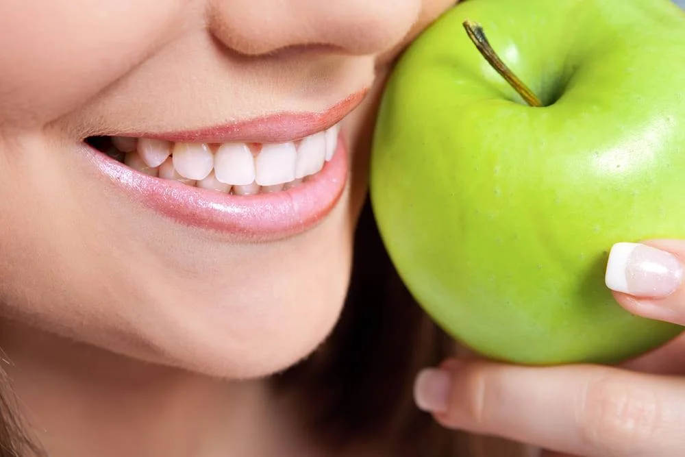 closeup teeth with apple